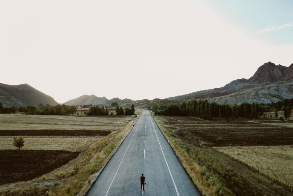 Person walking down long road